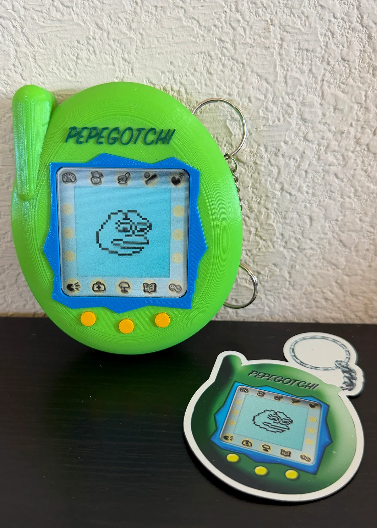 1 PEPEGOTCHI keychain, 1 PEPEGOTCHI Rare Pepe NFT on an Opendime and 1 PEPEGOTCHI fridge magnet